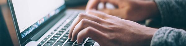 close up of hands typing